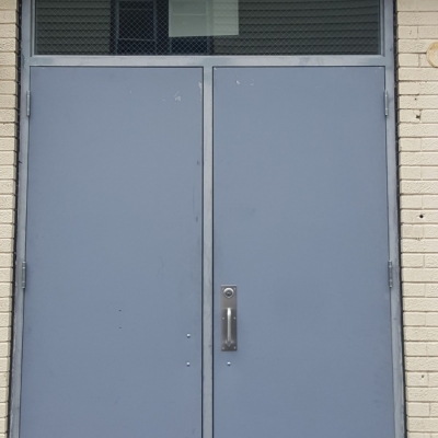 Pair of steel doors with glass transom.