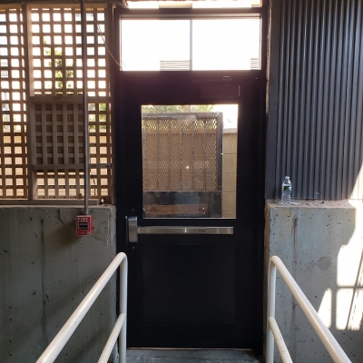 Custom made wide style dark bronze anodized aluminum garage door.